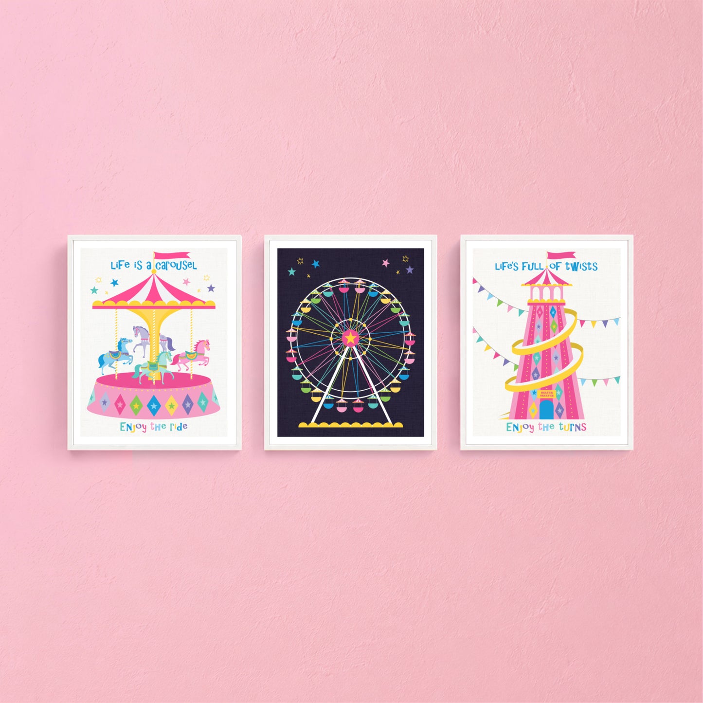 Three colorful framed prints above a crib with a bunting banner.