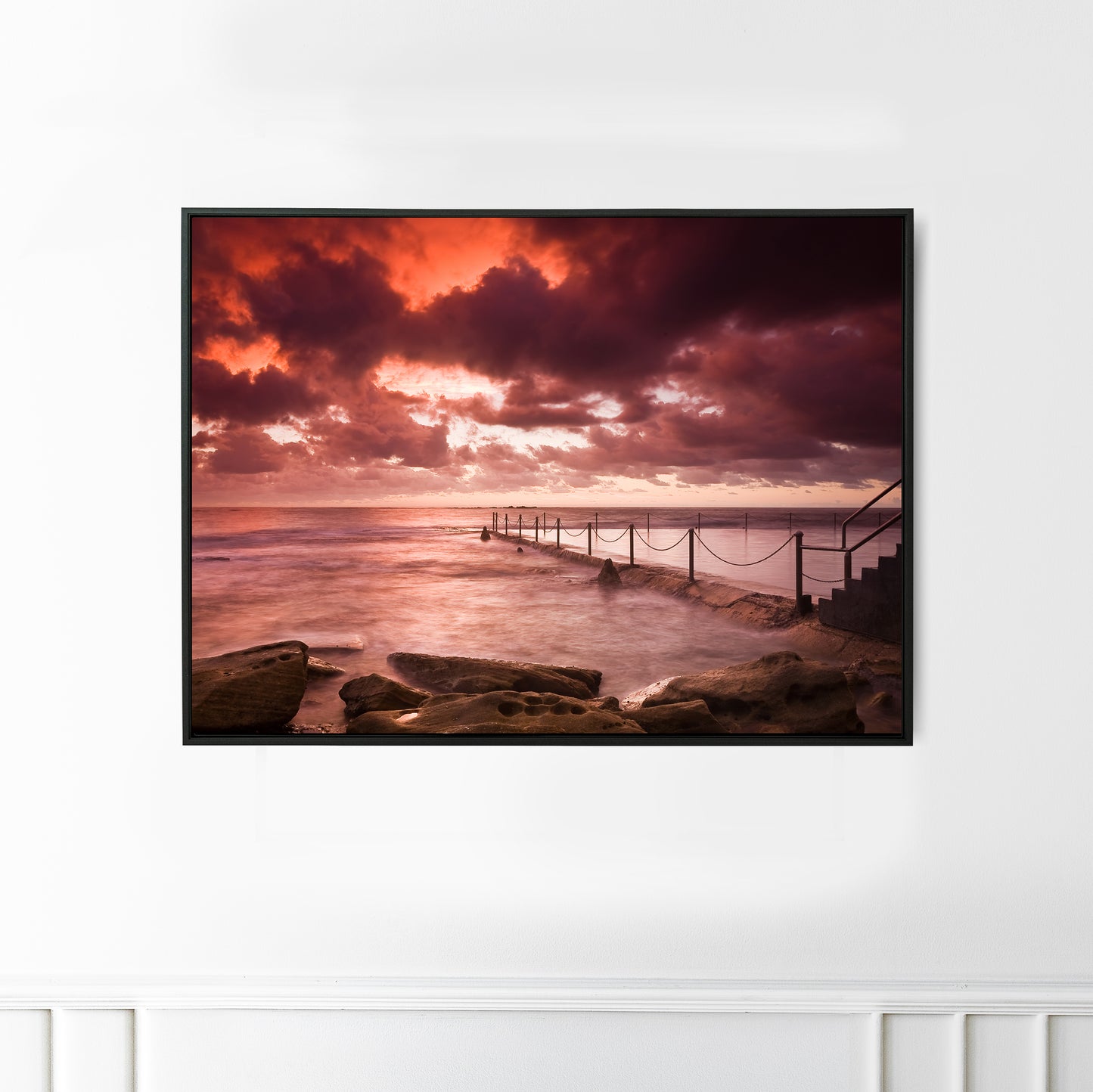 An intense red sunrise at Coogee Beach ocean rock pool, Sydney.