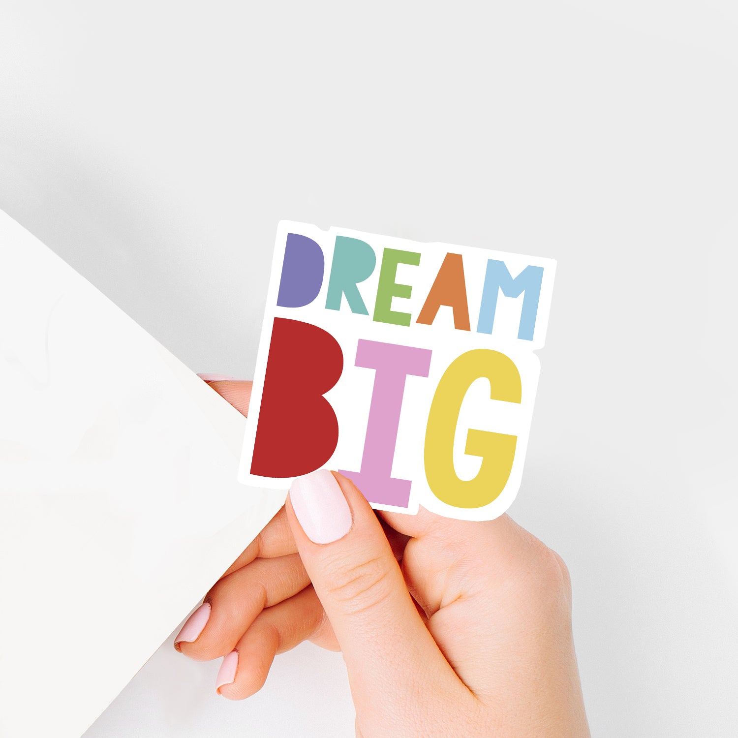 hand holding DREAM BIG colourful sticker