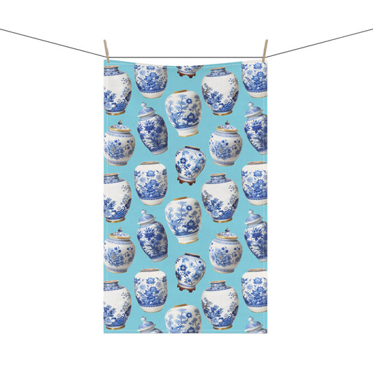 beautiful tea towel, showcasing blue and white ginger jars against a soft light blue background