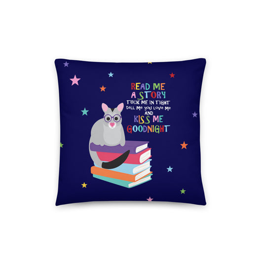 cushion cover is decorated with a little possum sitting on a stack of books with the words 'Read me a story, tuck me in tight, tell me you love me and kiss me goodnight'