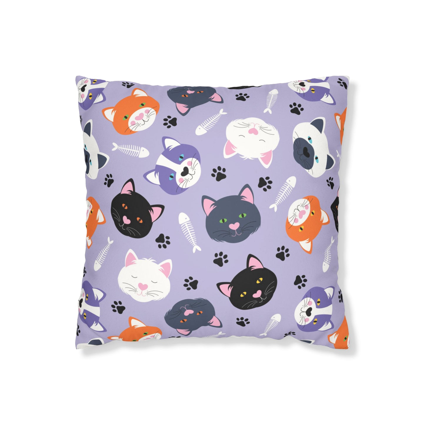 cushion cover is full of adorable cat faces in various colours against a soft lavender background. Accompanied by playful paw prints and fishbone motifs.
