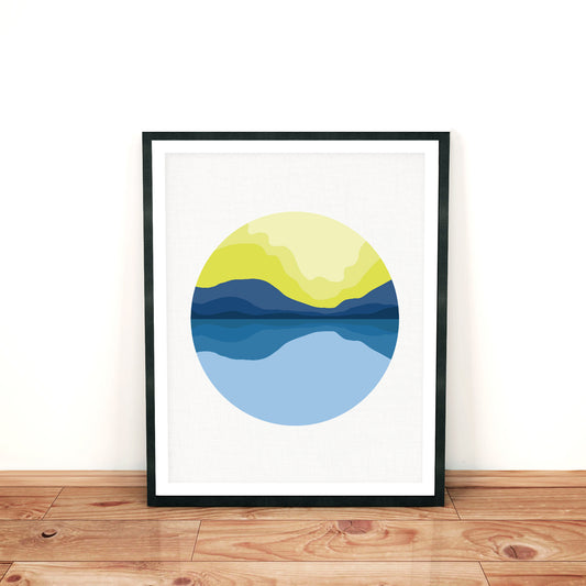 modern mountain landscape print in blue and yellow in a frame