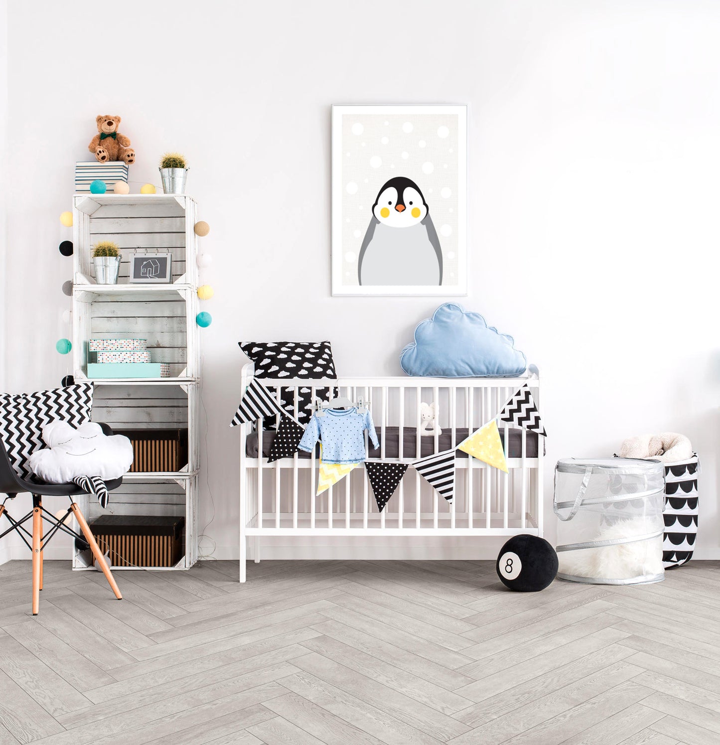 Winter themed baby nursery with large penguin print and blue, yellow and black and white decor