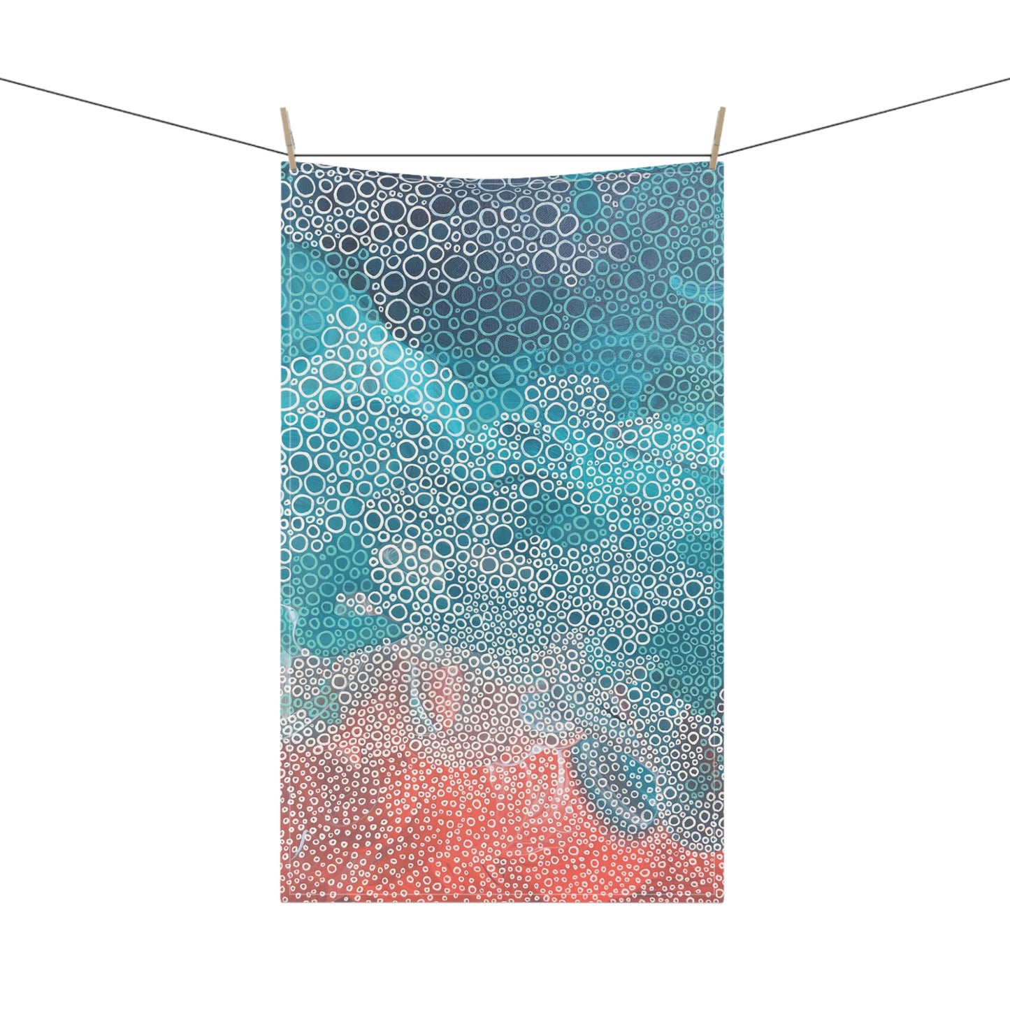 striking tea towel, featuring a soothing mix of seafoam turquoises, blues, and coral tones