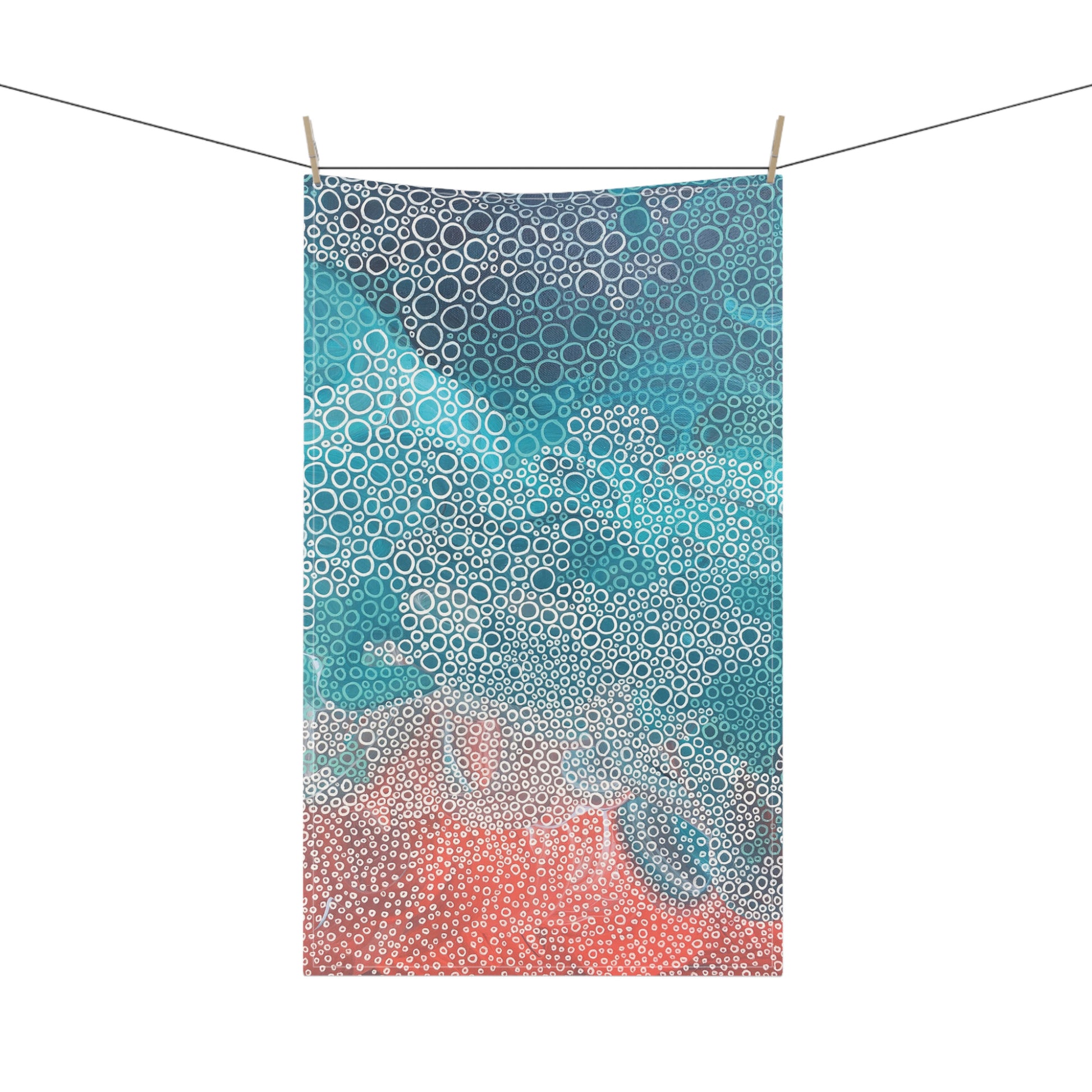 striking tea towel, featuring a soothing mix of seafoam turquoises, blues, and coral tones