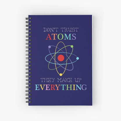 dark blue spiral notebook with Don't trust atoms on cover