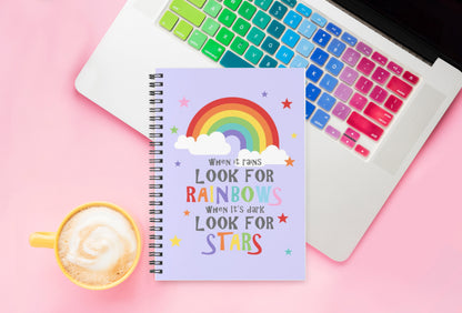 Look for rainbows spiral notebook sitting on a laptop in colourful office