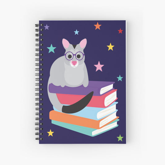 Spiral notebook with cute little illustration of a possum sitting on a stack of books