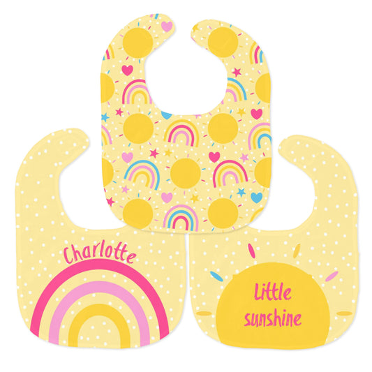 Adorable summer sunshine themed baby bib set with a cheerful and vibrant design of rainbows and sunshine, a “Little Sunshine” bib and personalised baby bib