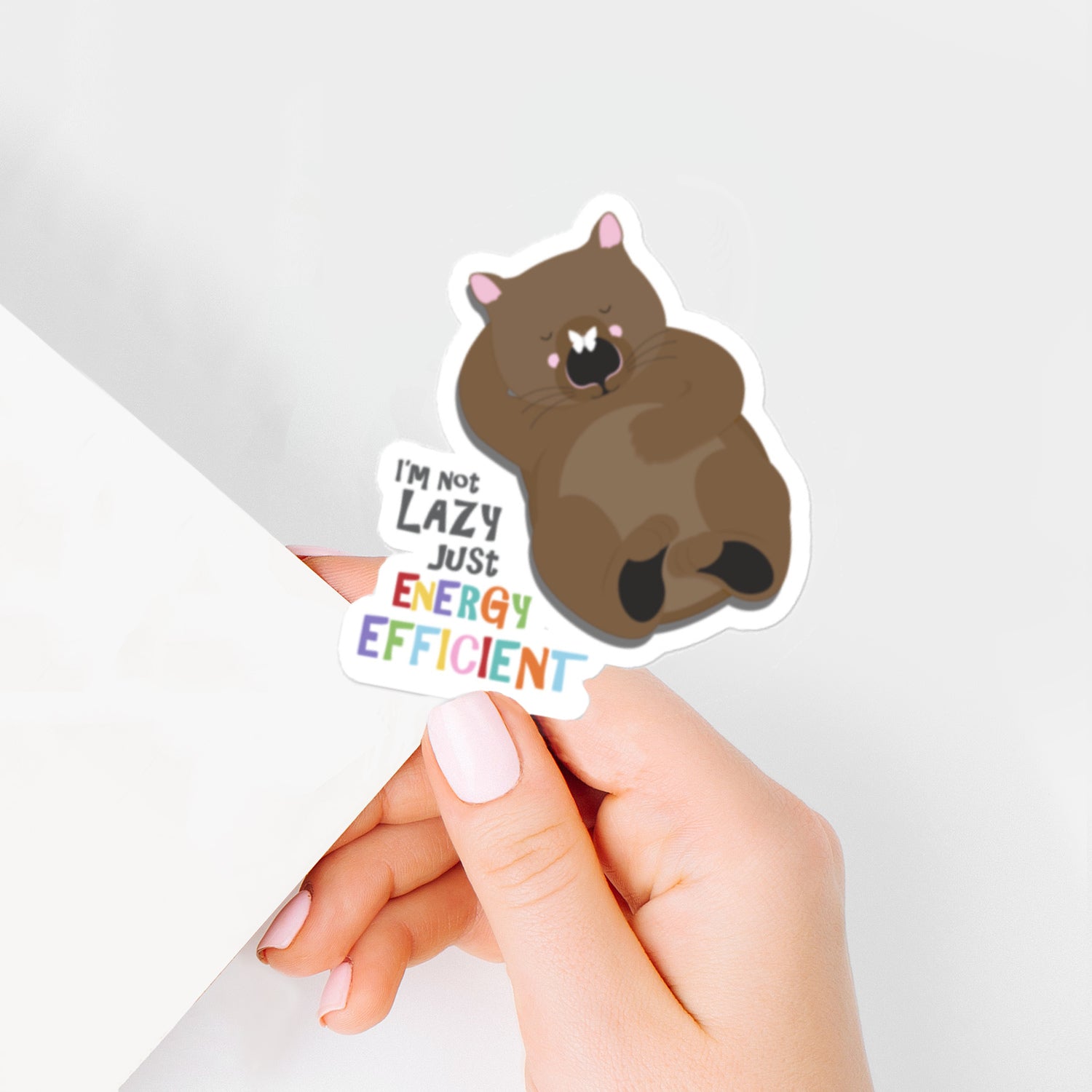 relaxing wombat Sticker with "I'm not lazy just energy efficient."
