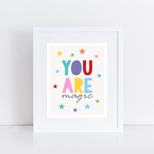 bold and bright "You are magic" poster in rainbow colours and a scattering of stars. 