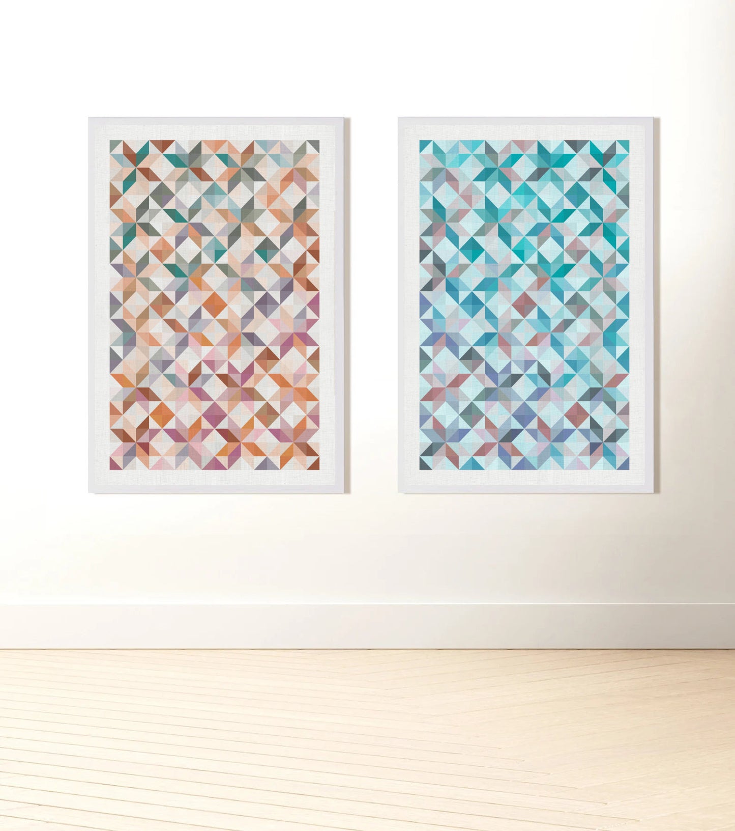 Two prints of traditional patchwork patterns one mostly orange and one blue based, hanging on a wall