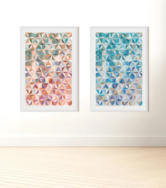 pattern prints of stars and cubes in two colour options - predominantly shades of blue or orange/pinks hanging on wall
