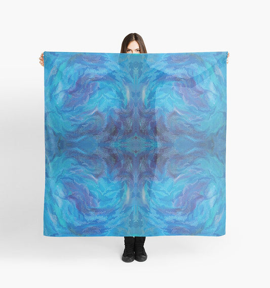 big blue woman's scarf with abstract design being held up 
