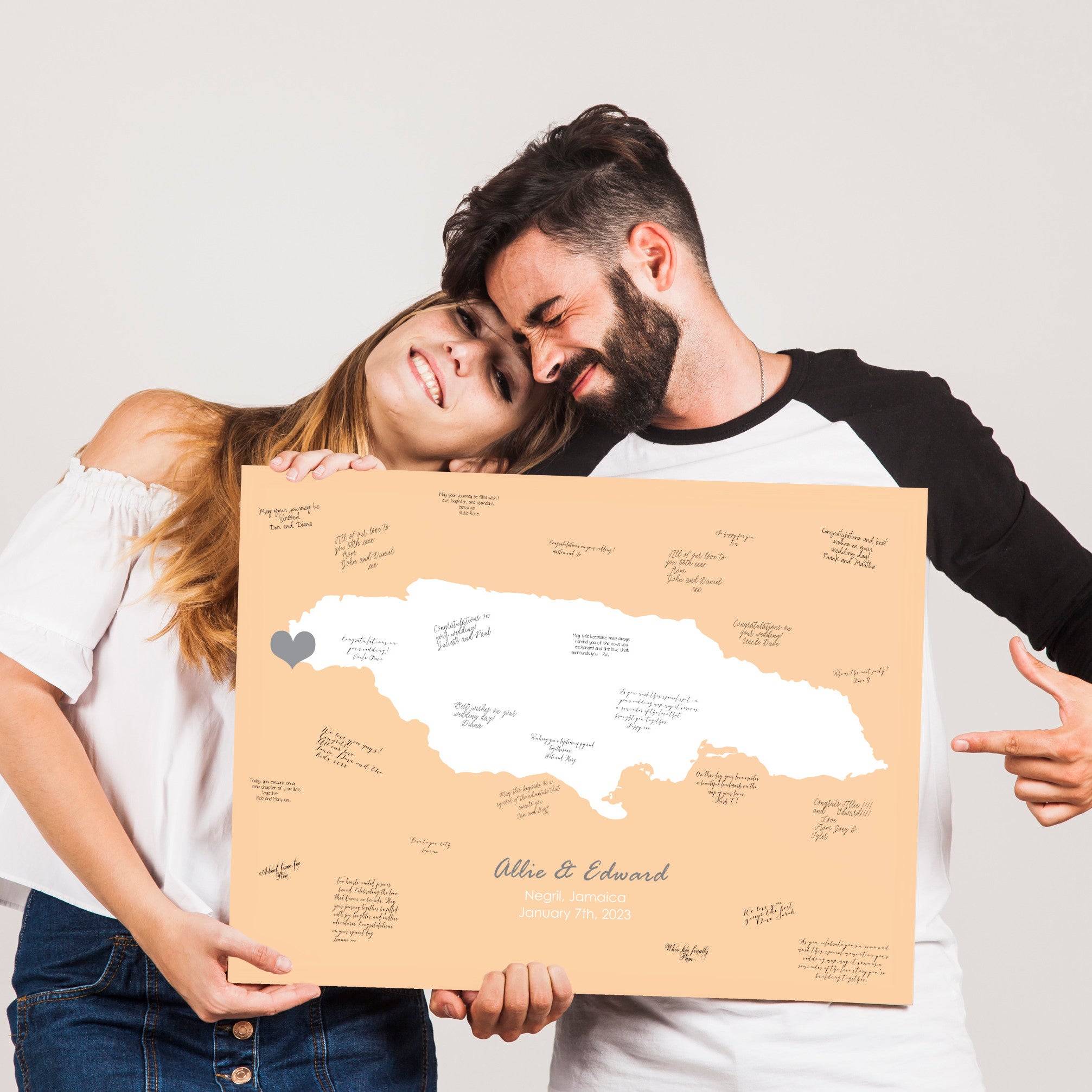 couple holding a personalised print of their wedding location