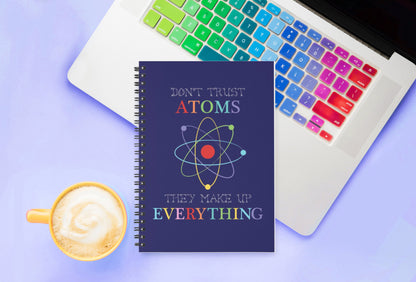 funny science themed cover, this spiral notebook sitting on laptop