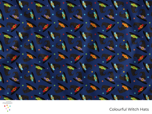 Colourful black witch hats with bright bands and stars on a navy background in a repeating Halloween surface pattern by Creative Monsoon.