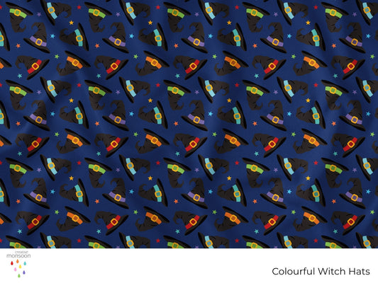 Colourful black witch hats with bright bands and stars on a navy background in a repeating Halloween surface pattern by Creative Monsoon.