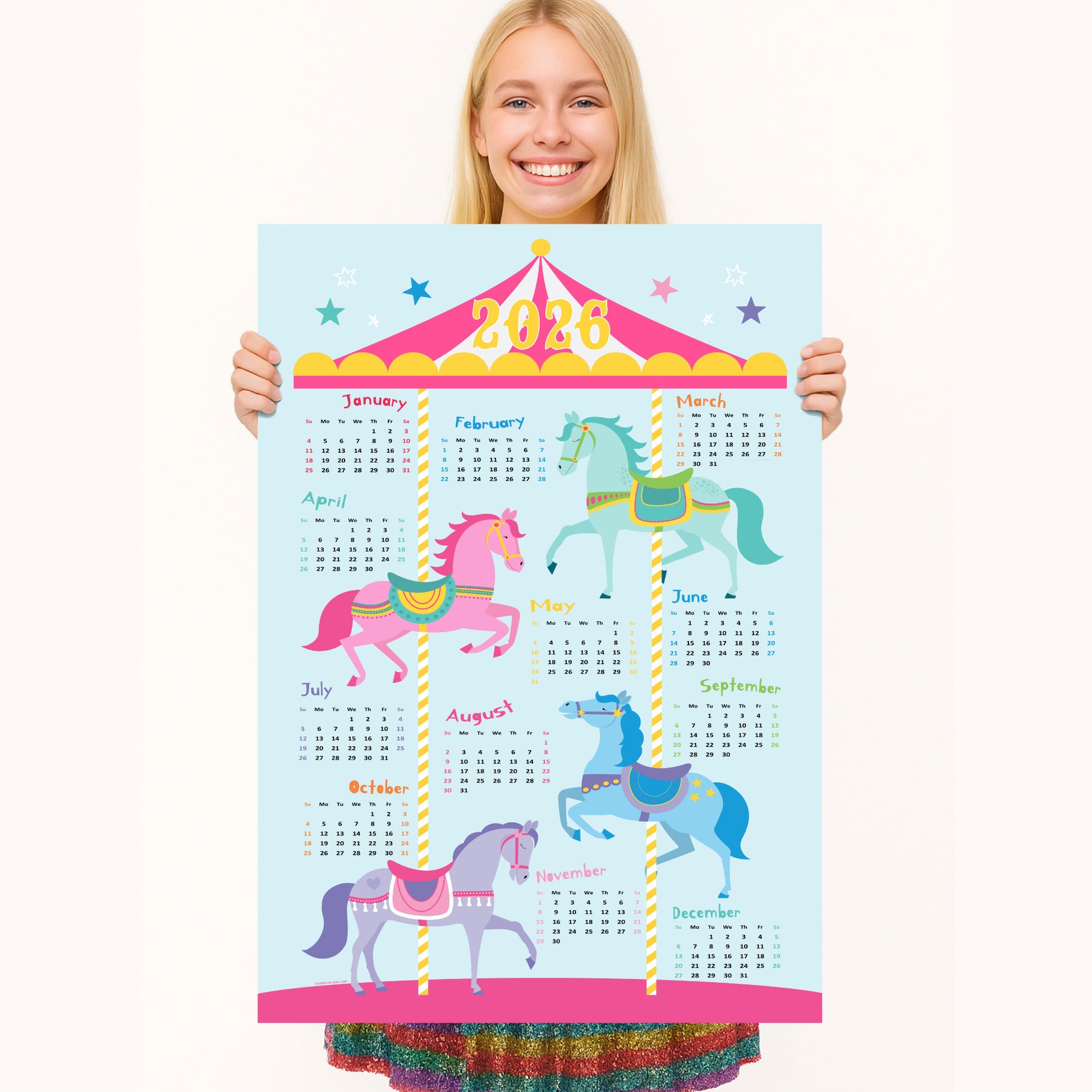 Person holding a colorful 2026 calendar with carousel horses design