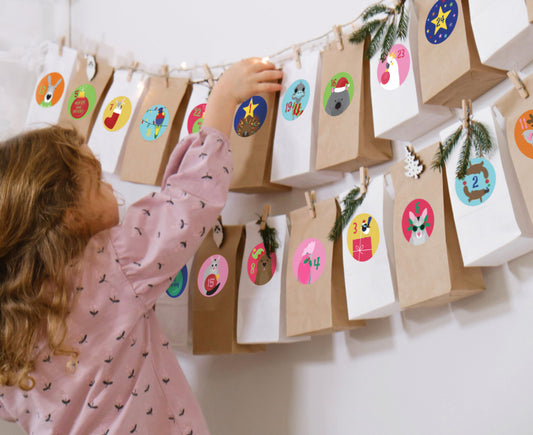 Girl opening DIY advent calendar decorated with colourful Australian animal stickers