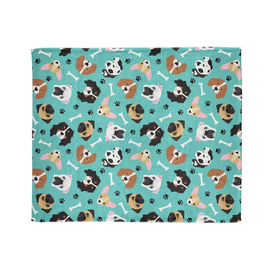 adorable blanket featuring puppy dog faces against a cheerful turquoise background. Playful paw prints and dog bone motifs add an extra touch of charm to the design