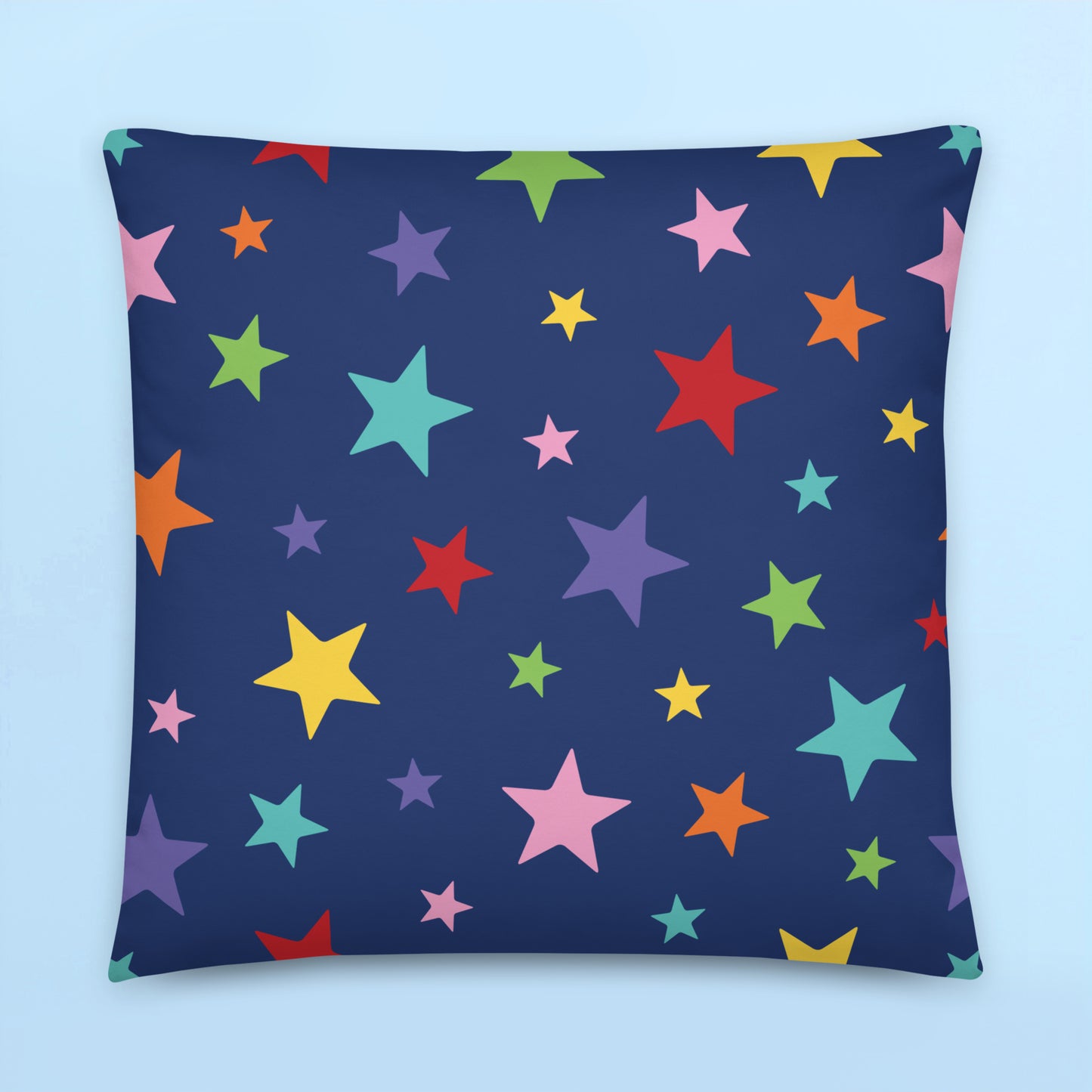 Rainbow stars pattern cushion cover on dark navy background for colourful kids room decor and playful space themed interiors.