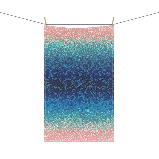 stunning tea towel, featuring a mesmerising gradient of blues, turquoise, and pinks with intricate circular pattern