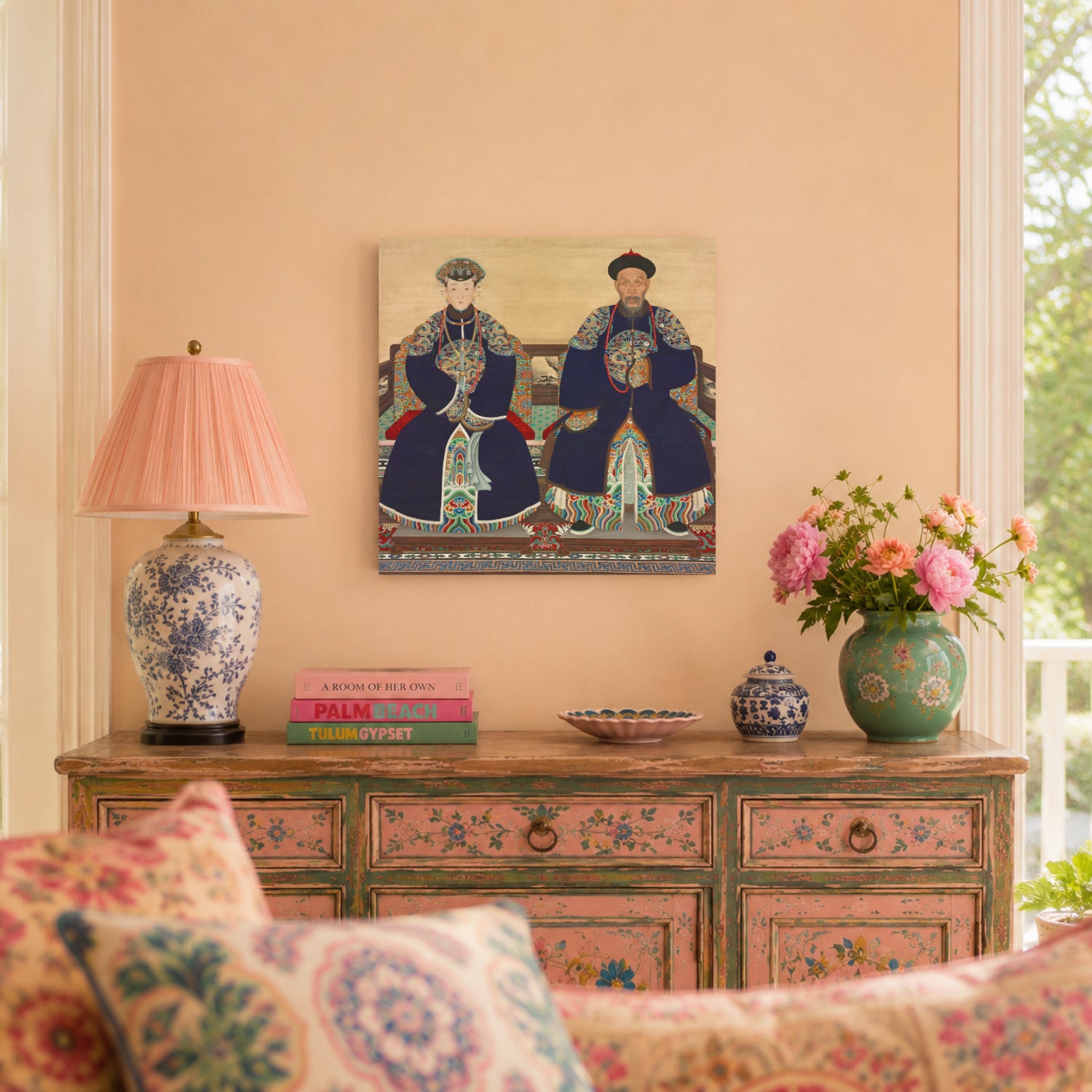 Decorative interior with a painting of two Chinese figures on a wall above a wooden dresser with floral patterns.