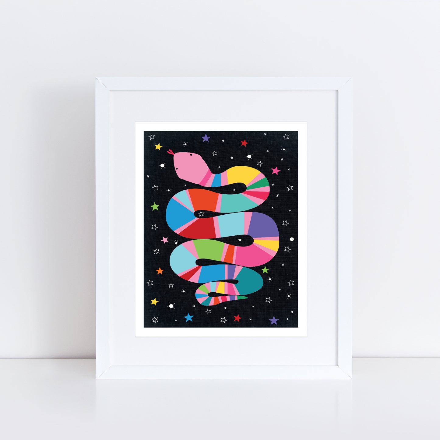 art print shows a colourful, coiled snake with bold stripes of pink, yellow, green, blue, and purple against a black starry background. Bright stars in different colours surround the snake, creating a fun cosmic vibe.