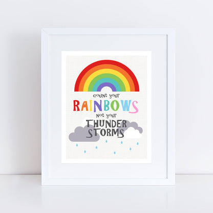  rainbow themed print for baby's nursery in white frame reads "Count your rainbows not your thunder storms" 