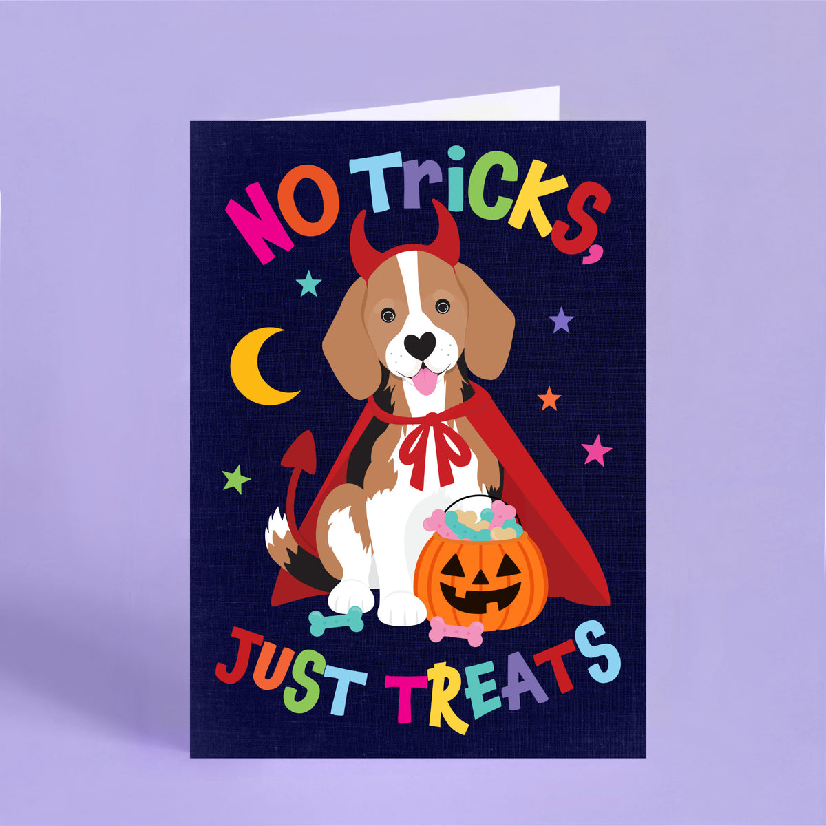 Funny Halloween card featuring a beagle dressed as a devil holding a pumpkin bucket with the words "No Tricks, Just Treats".