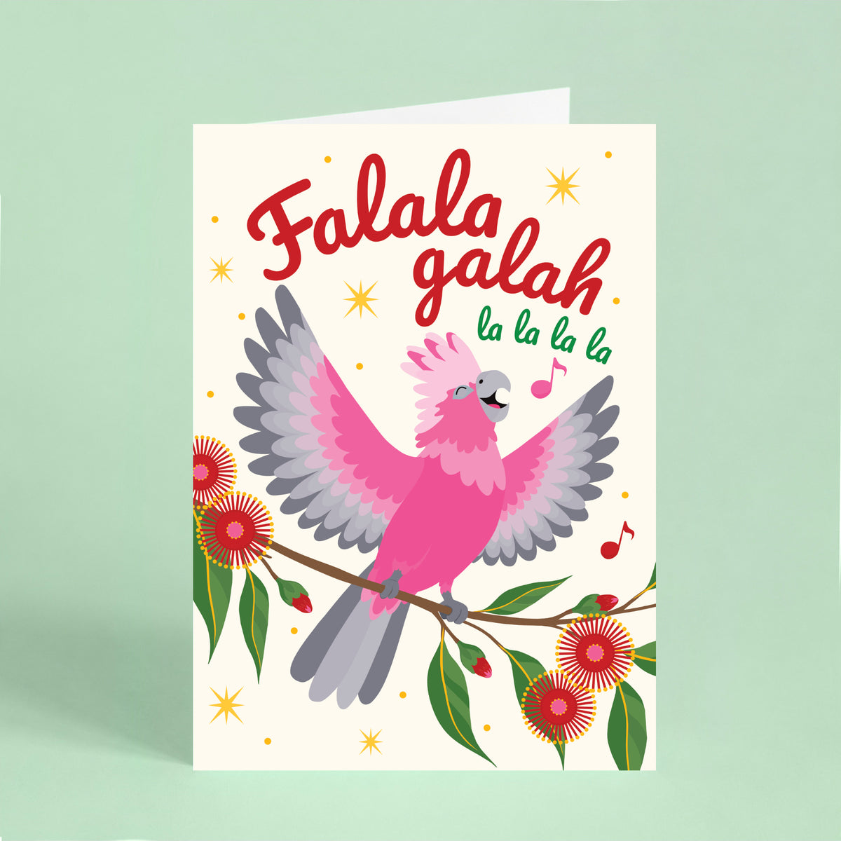 Australian Christmas card featuring a singing galah with flowering gum leaves, music notes and the words “Falala Galah la la la la”.