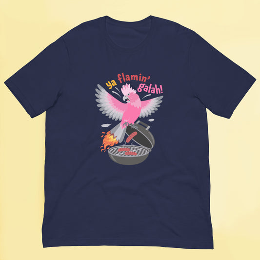 Funny Australian galah t shirt featuring a pink galah flying above a BBQ with flaming tail feathers and “ya flamin’ galah!” text.