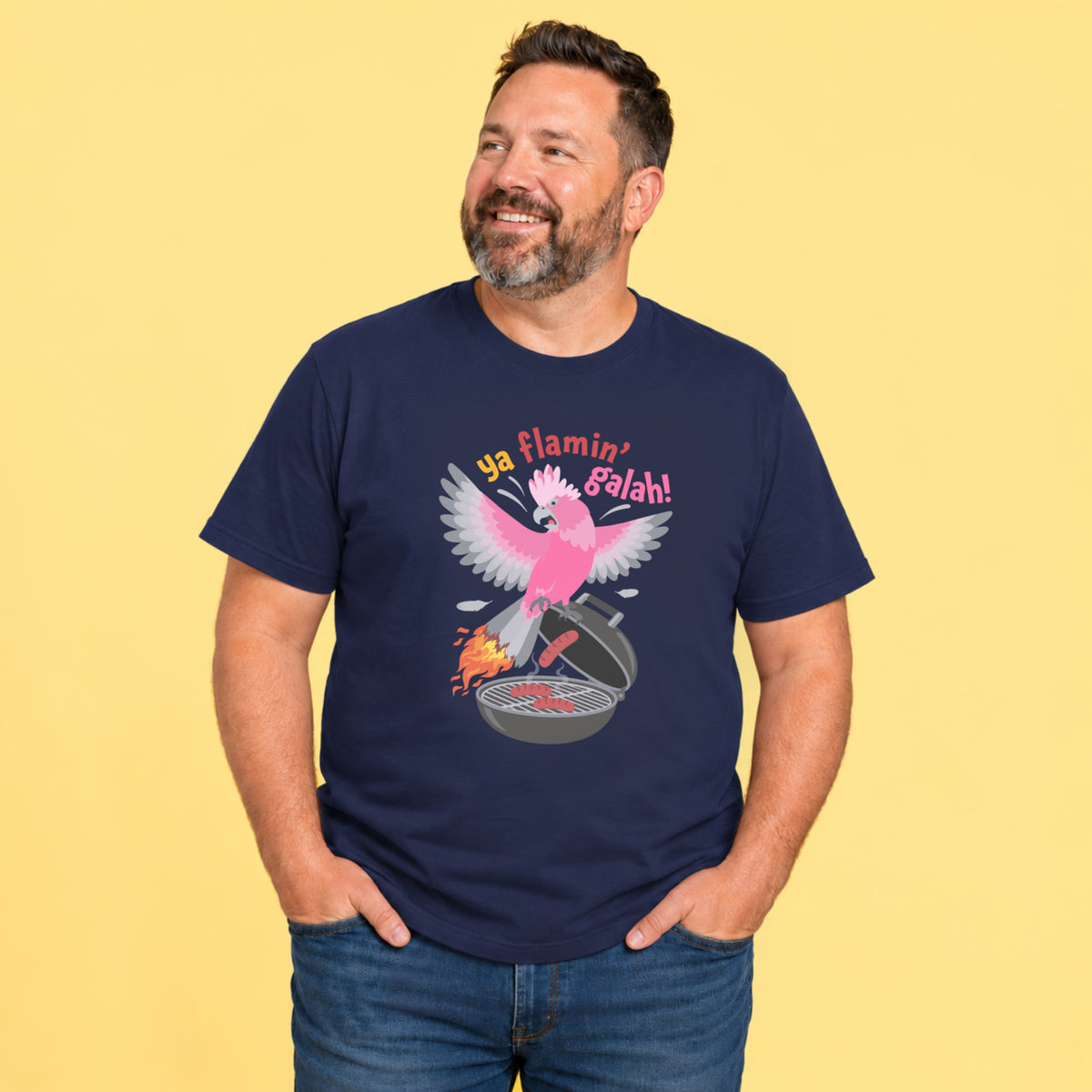 Adult model wearing a Ya Flamin’ Galah funny Australian t shirt featuring a colourful pink galah and BBQ illustration.