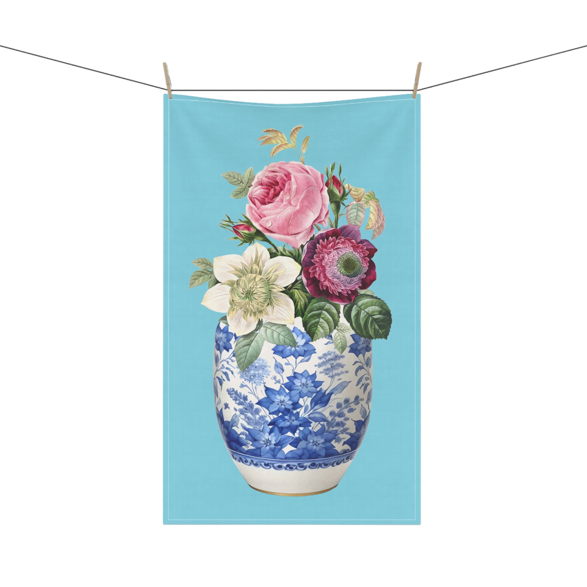 Light blue  tea towel, showcasing a beautiful blend of pink roses and delicate anemone flowers elegantly displayed in a classic blue and white china ginger jar