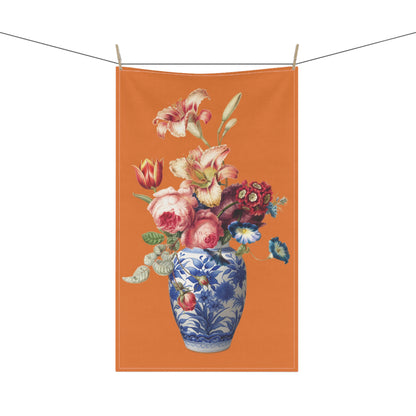 charming tea towel, featuring a vibrant bouquet of lilies and roses elegantly displayed in a timeless blue and white china ginger jar against a bold orange background