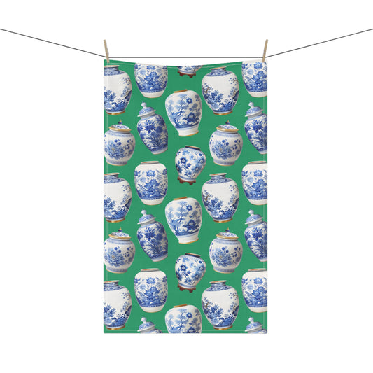 gorgeous tea towel, featuring blue and white ginger jars set against a vibrant green background.