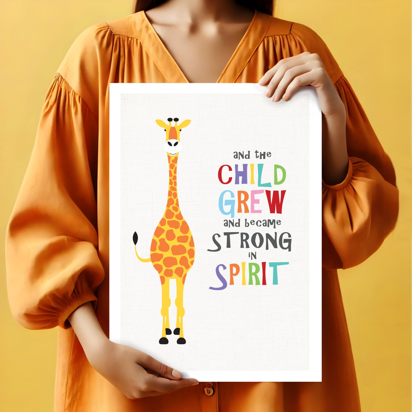 woman holding Colourful fun giraffe art print with bible quote 'And the Child Grew and became strong in spirit'