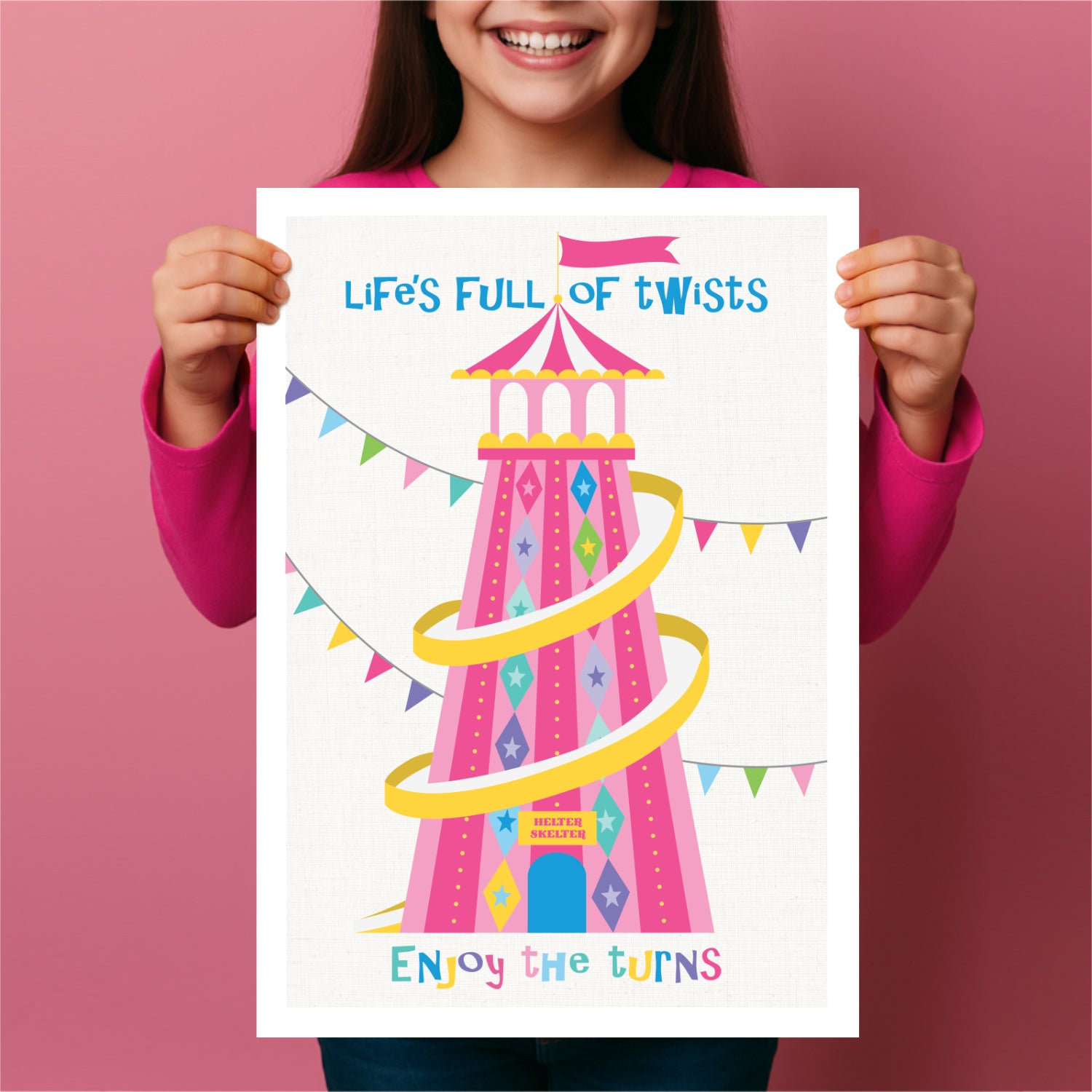 Child holding a poster with a colorful illustration of a helter skelter and text on a pink background
