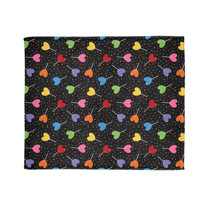 vibrant blanket, featuring colourful heart-shaped lollipops and cheerful sprinkles on a bold black background