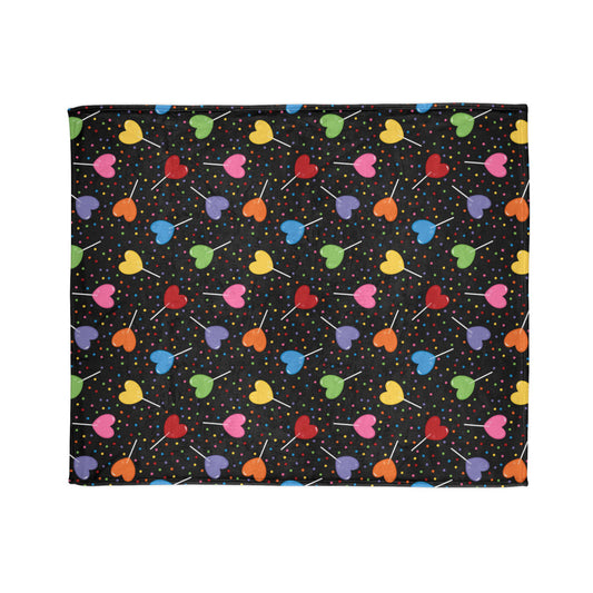 vibrant blanket, featuring colourful heart-shaped lollipops and cheerful sprinkles on a bold black background