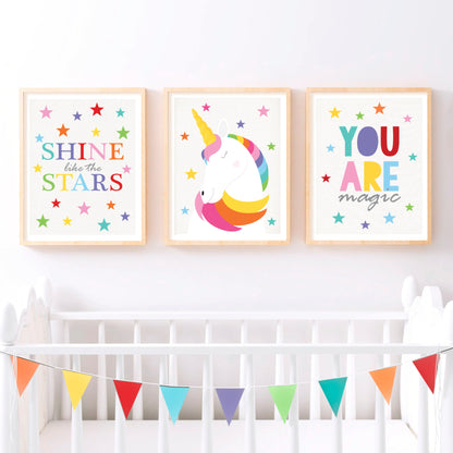Three unicorn themed kids art prints in a nursery above cot, shine like the stars, a unicorn and you are magic