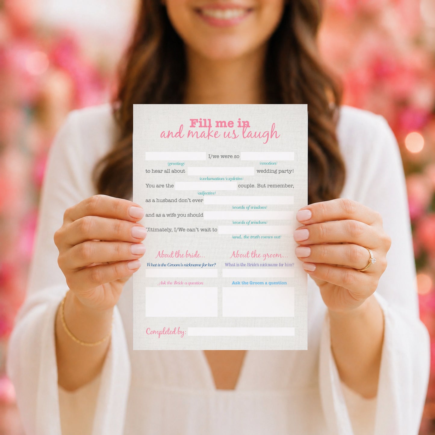 Woman holding a fill-in-the-blank card with a pink and white design for a wedding