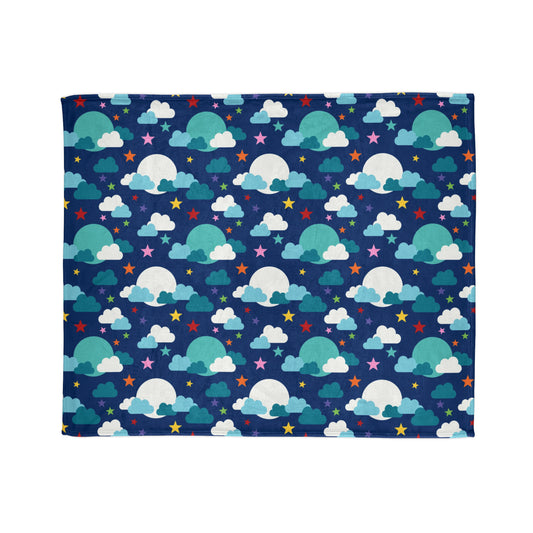 throw blanket, featuring a whimsical pattern of fluffy clouds, colourful stars, and glowing moons against a deep blue background.