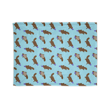 cozy blanket, featuring a charming platypus pattern on a calming aqua background