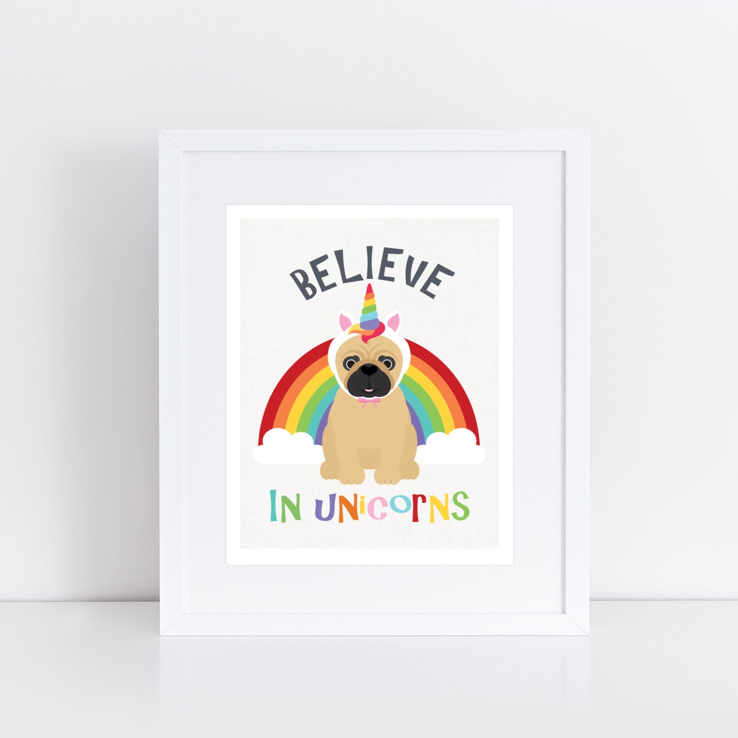 Pug dog infant of rainbow wearing a unicorn hat with the words Believe in unicorns Believe in unicorns believe in unicorns