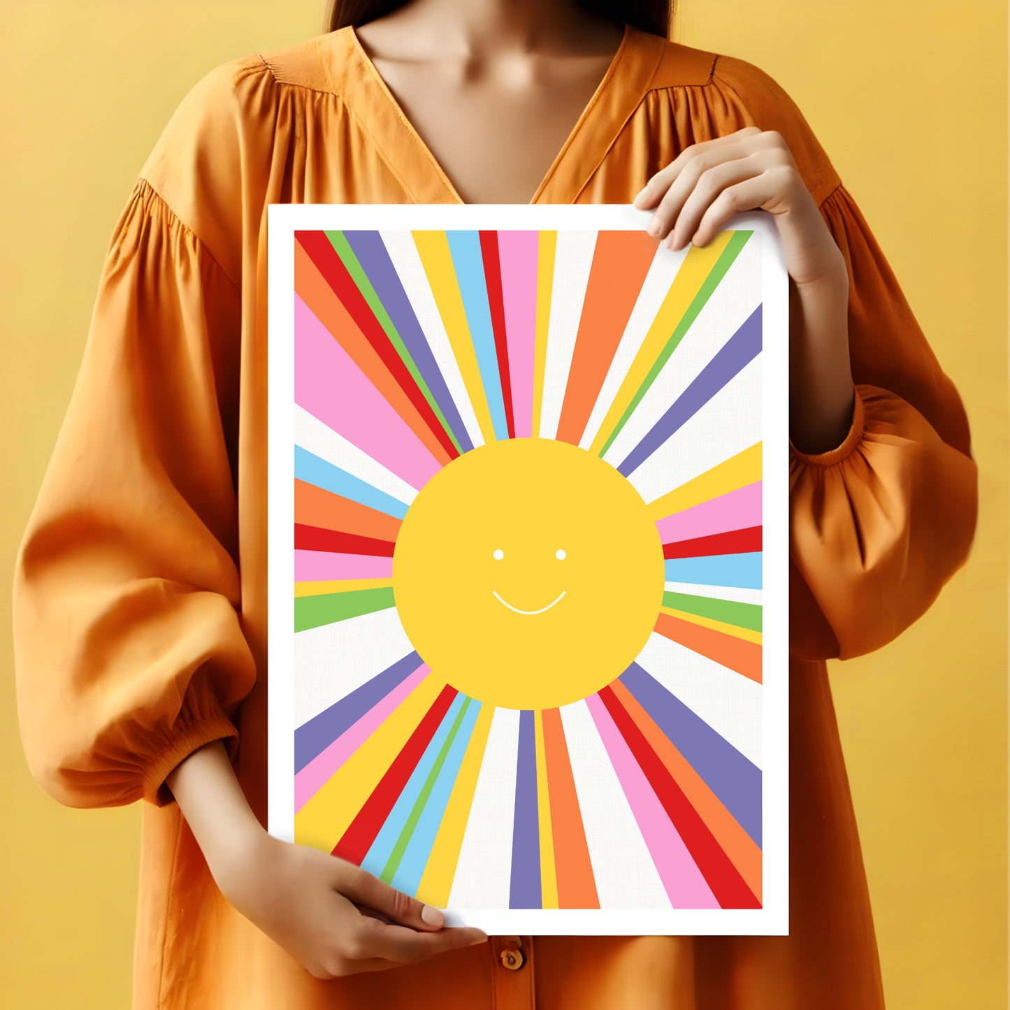 Woman holding a childs smiling sun printed artwork with rainbow rays