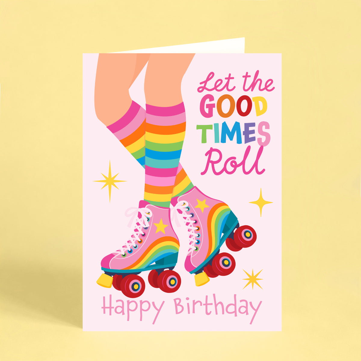 Colourful roller skate birthday card with pink rainbow skates, striped socks and Let the Good Times Roll Happy Birthday lettering.