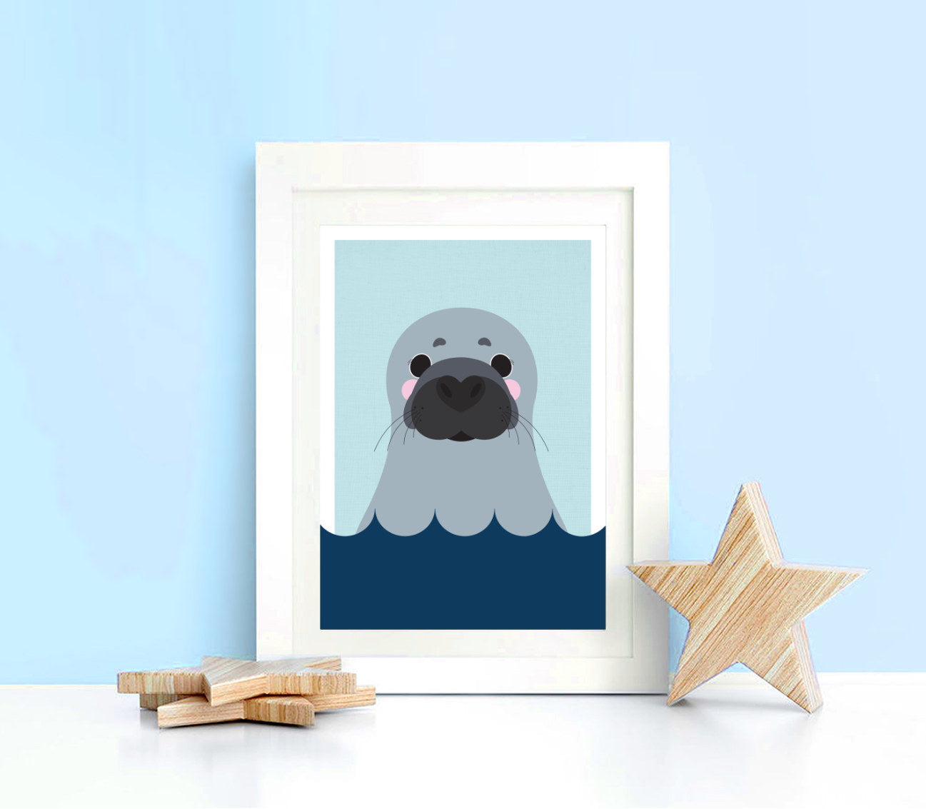 seal print framed in a kids nursery with blue walls
